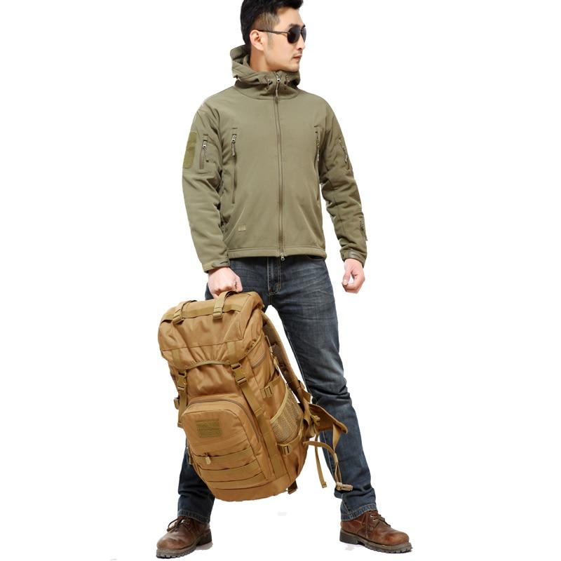 man-carrying-in-hand-large-capacity-tactical-military-backpack